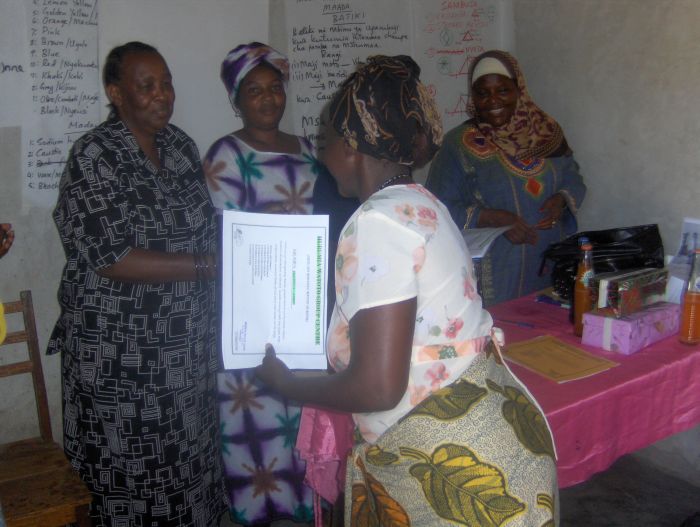 helping-widows-with-aids-in-Tanzania-handing-out-certifications.
